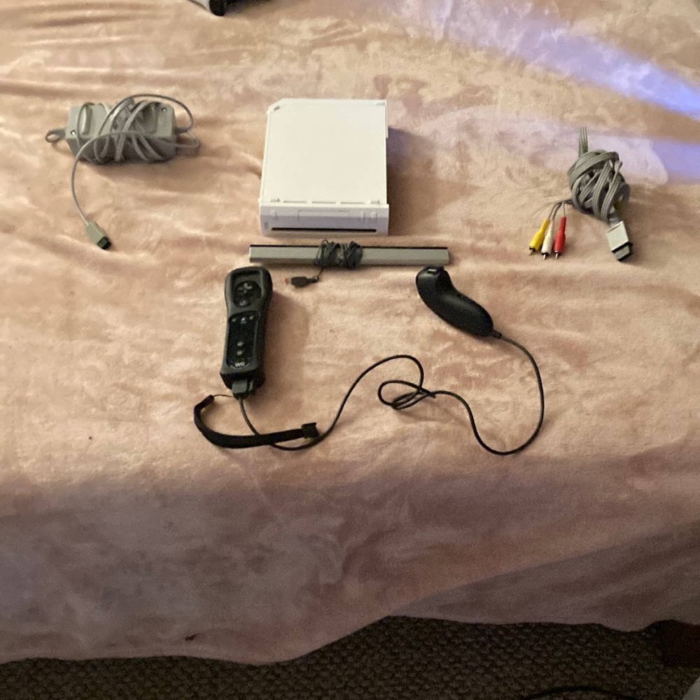 Wiii gaming console comes with controller and cables needed for setup.